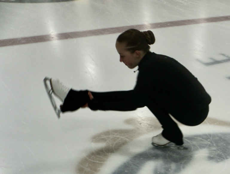 figure skater displaying her test she has just passed